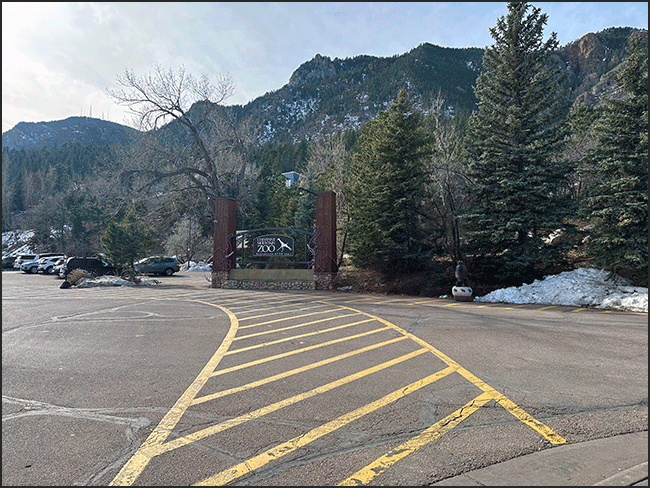 Walkway crosswalk to elevation sign front area of Zoo