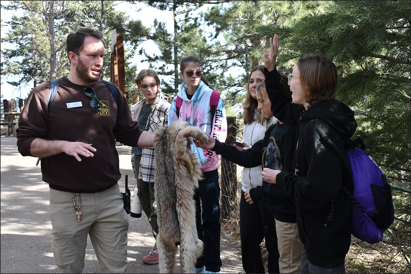 Outdoor School scene with artifacts and instructor and students