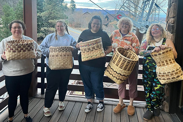 Outdoor School basket weaving class participants and their project