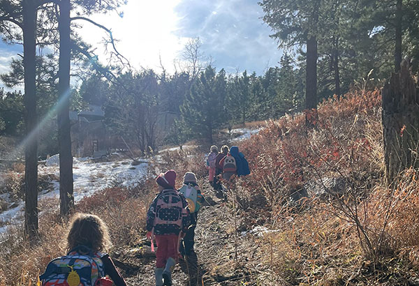 Outdoor school kids hiking in wilderness